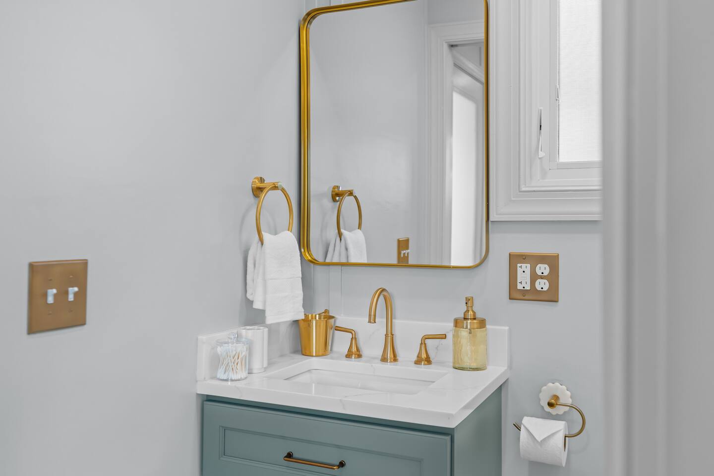 Vanity with brass faucet and mirror
