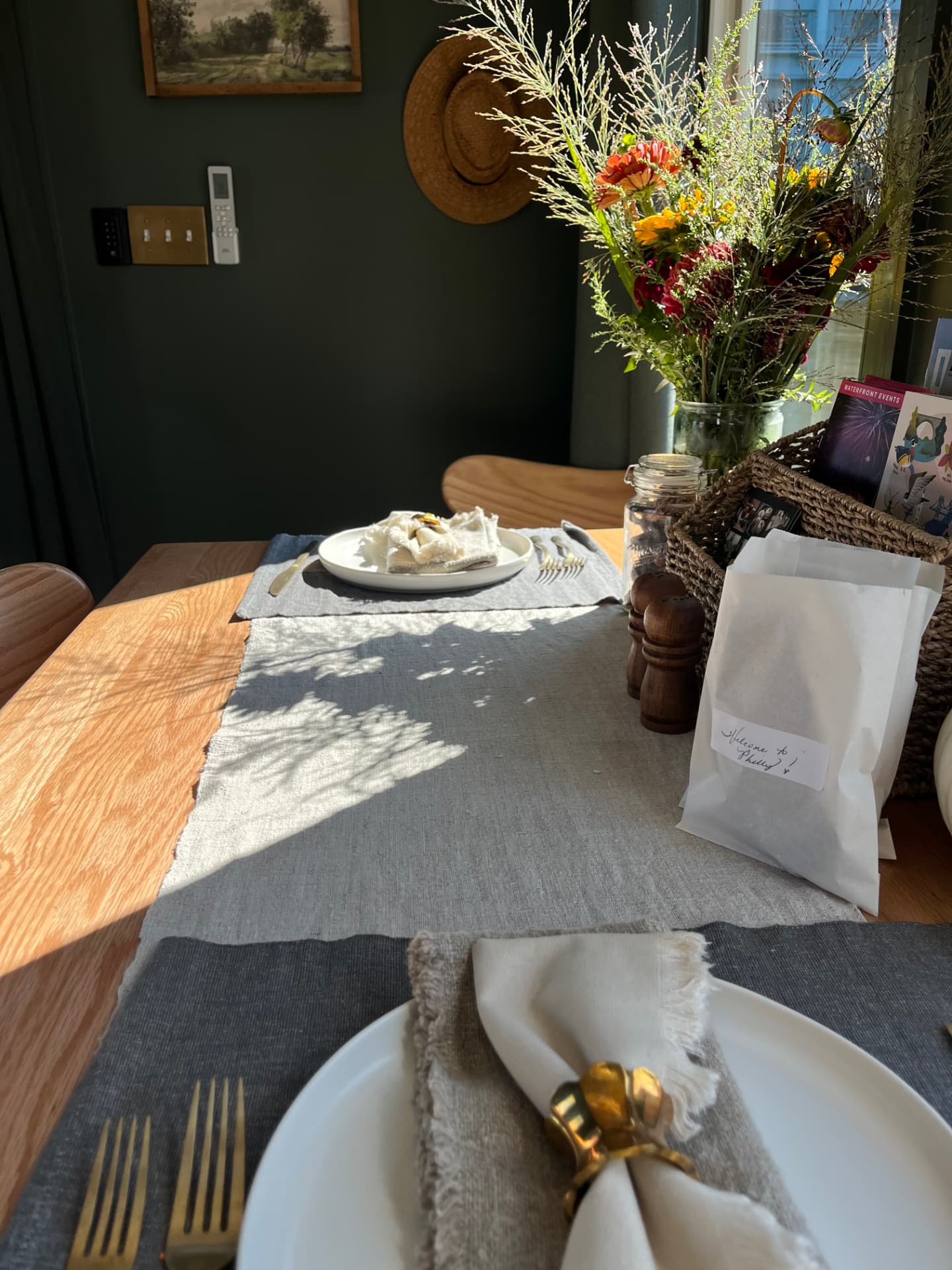 The dining table set for dinner with a welcome bag from Philly