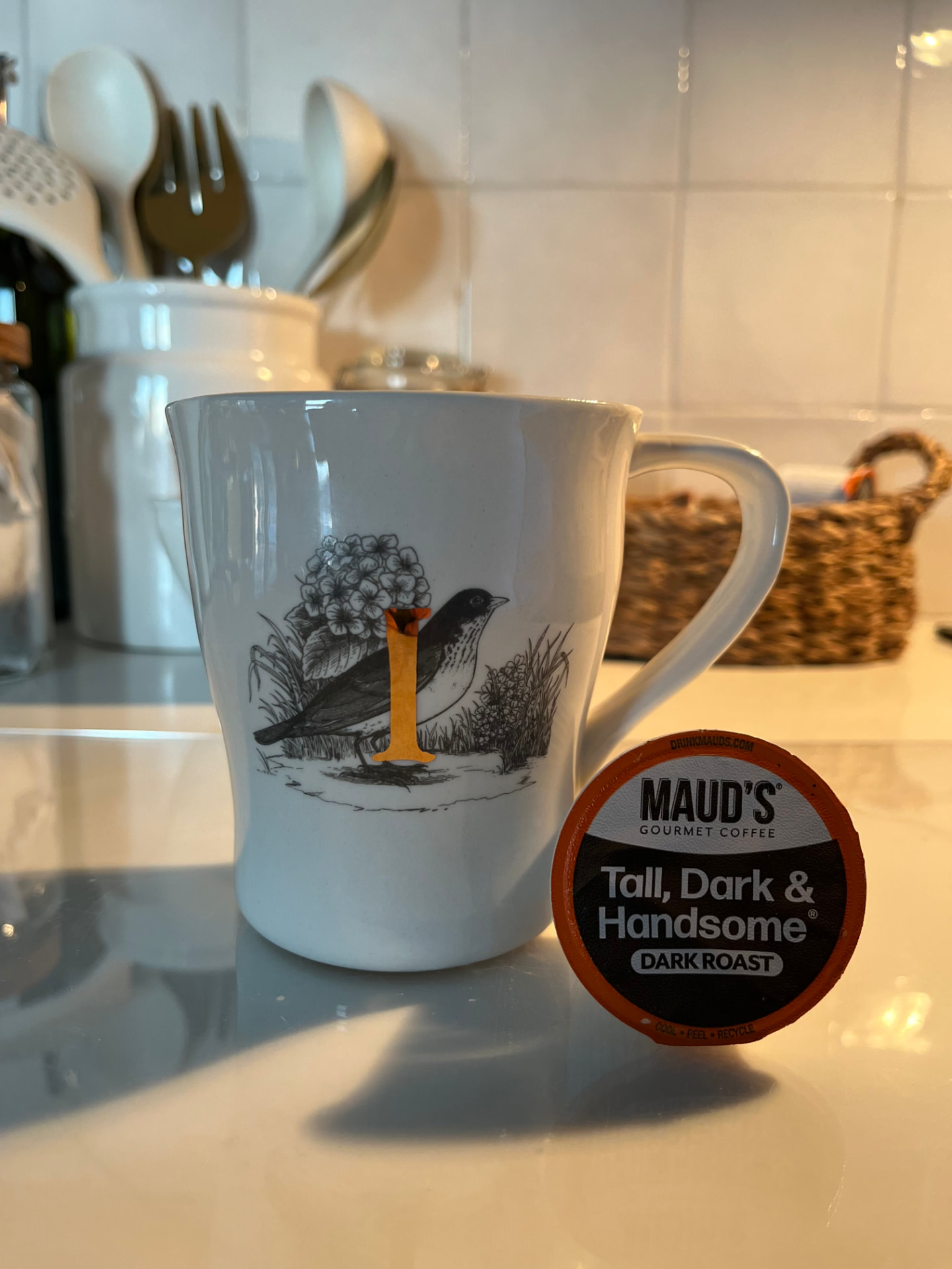 A coffee mug and pod on the kitchen counter