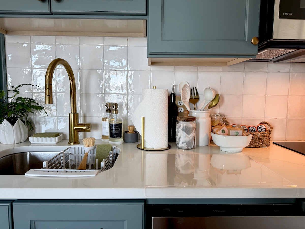 Kitchen with brass faucet and farmhouse sink
